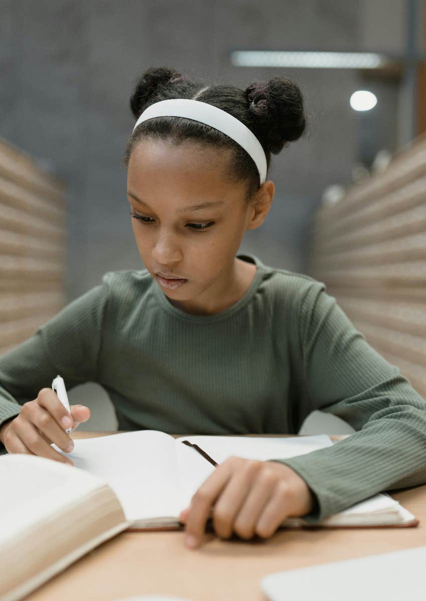 little girl reading and studying
