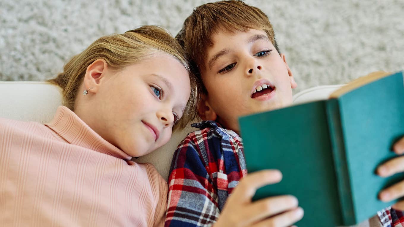 little boy and little girl reading a book together