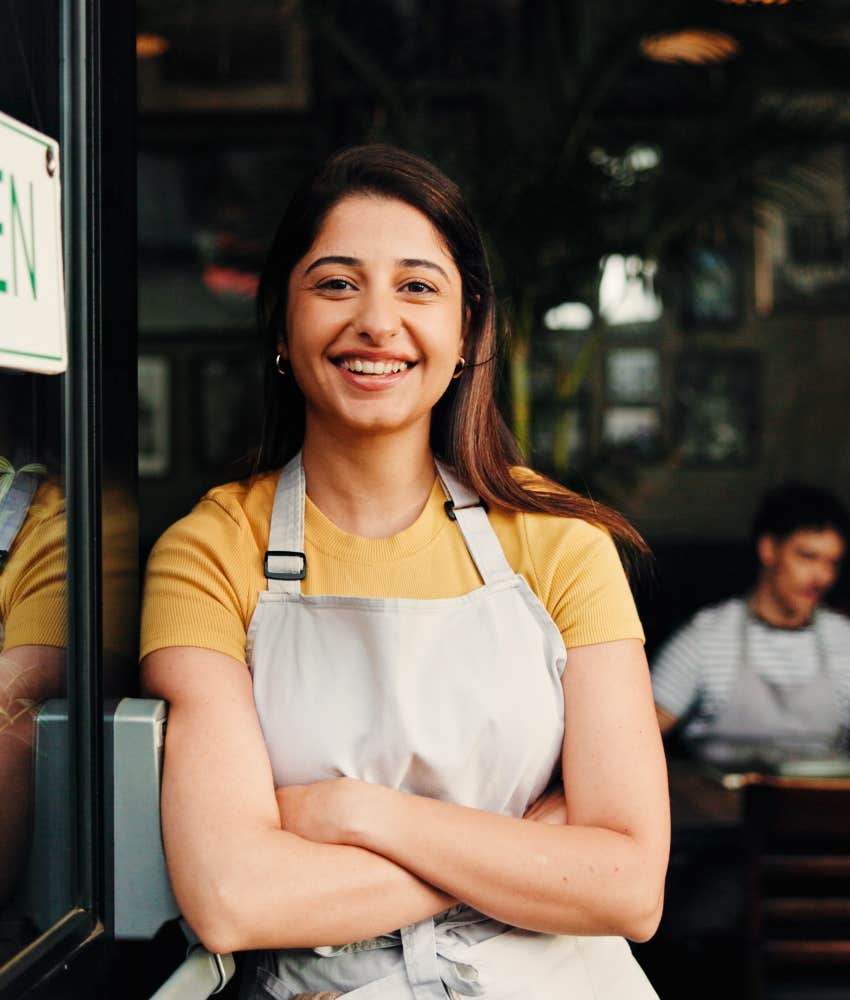Female restaurant owner welcoming new customers