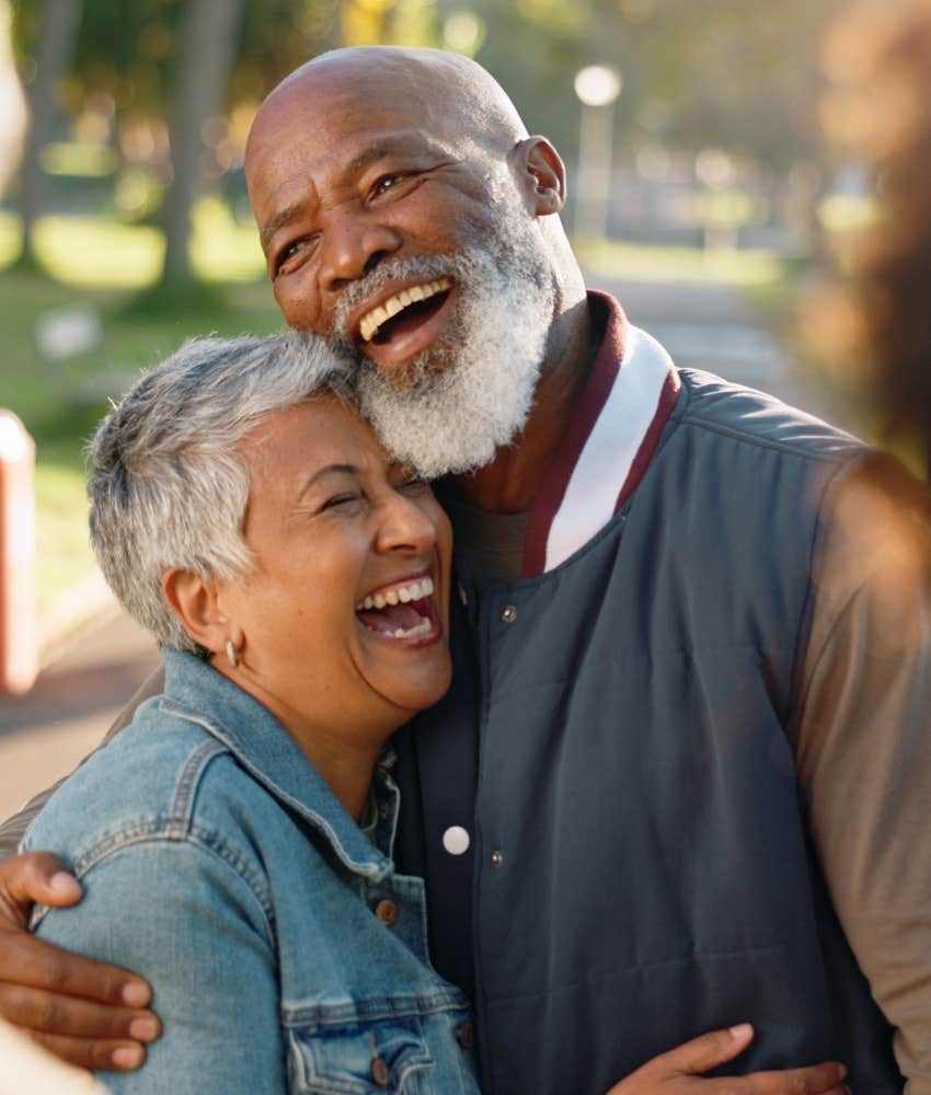 Happy long-married couple laughing because they have positive illusions 