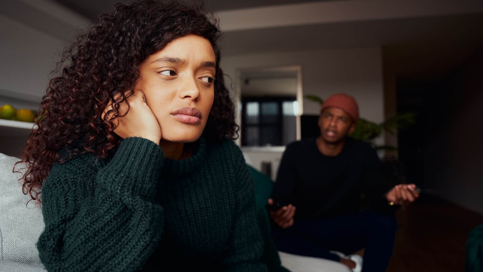 woman turned away from her husband who's stopped caring about her world