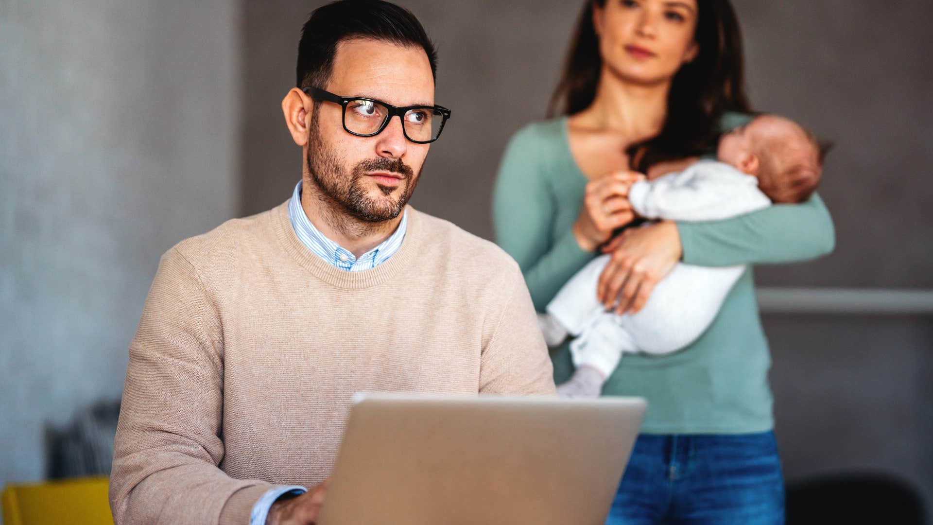 man who's stopped offering to help while wife holds their child