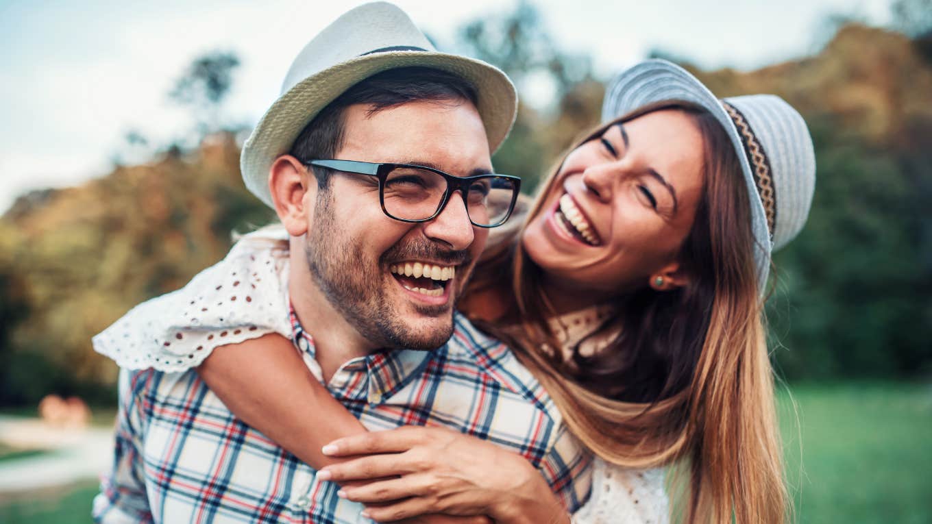 happy couple who are meant to be hugging each other and laughing