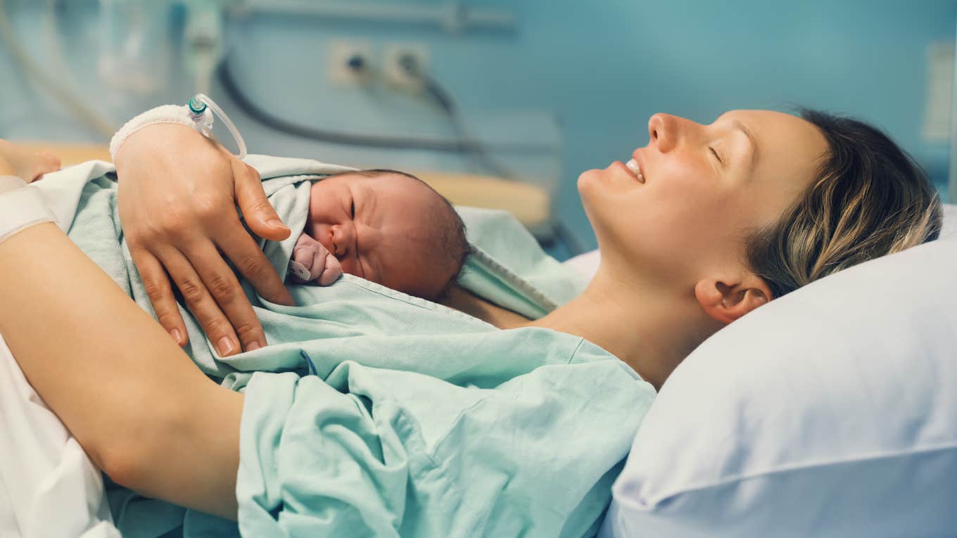 mom cuddling newborn baby in hospital