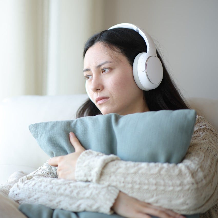 woman who is listening to sad songs as it drags down her energy