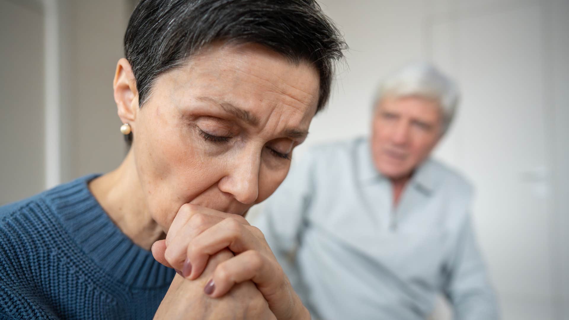 woman who lacks excitement in her tone of voice sitting with her husband