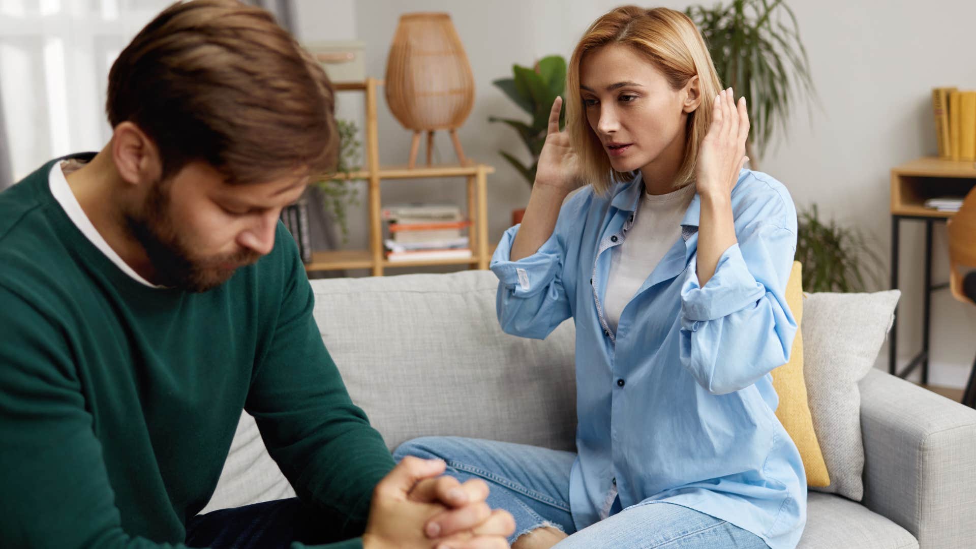 frustrated woman saying can we just talk to confused husband