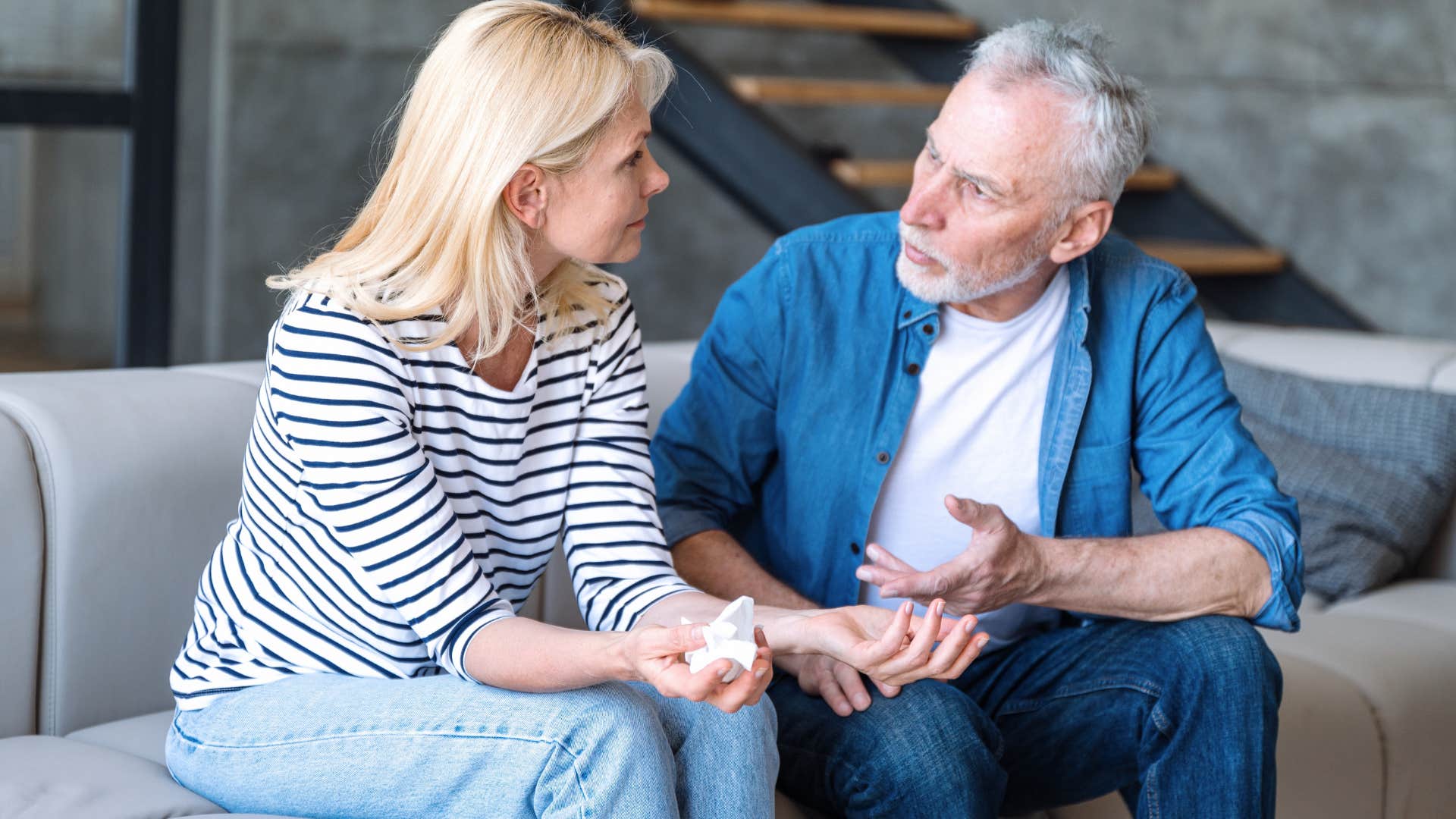 older couple arguing on the couch