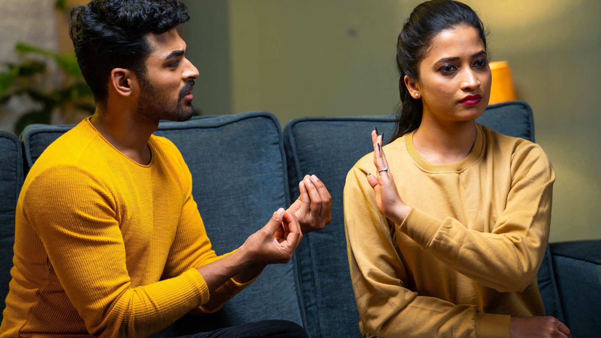 woman putting her hand up to husband 