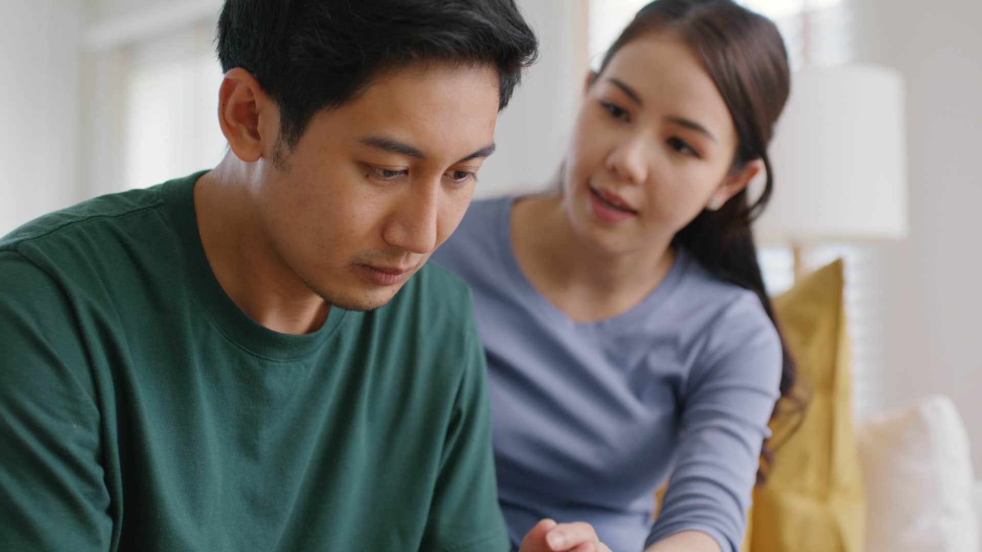 woman comforting concerned upset husband
