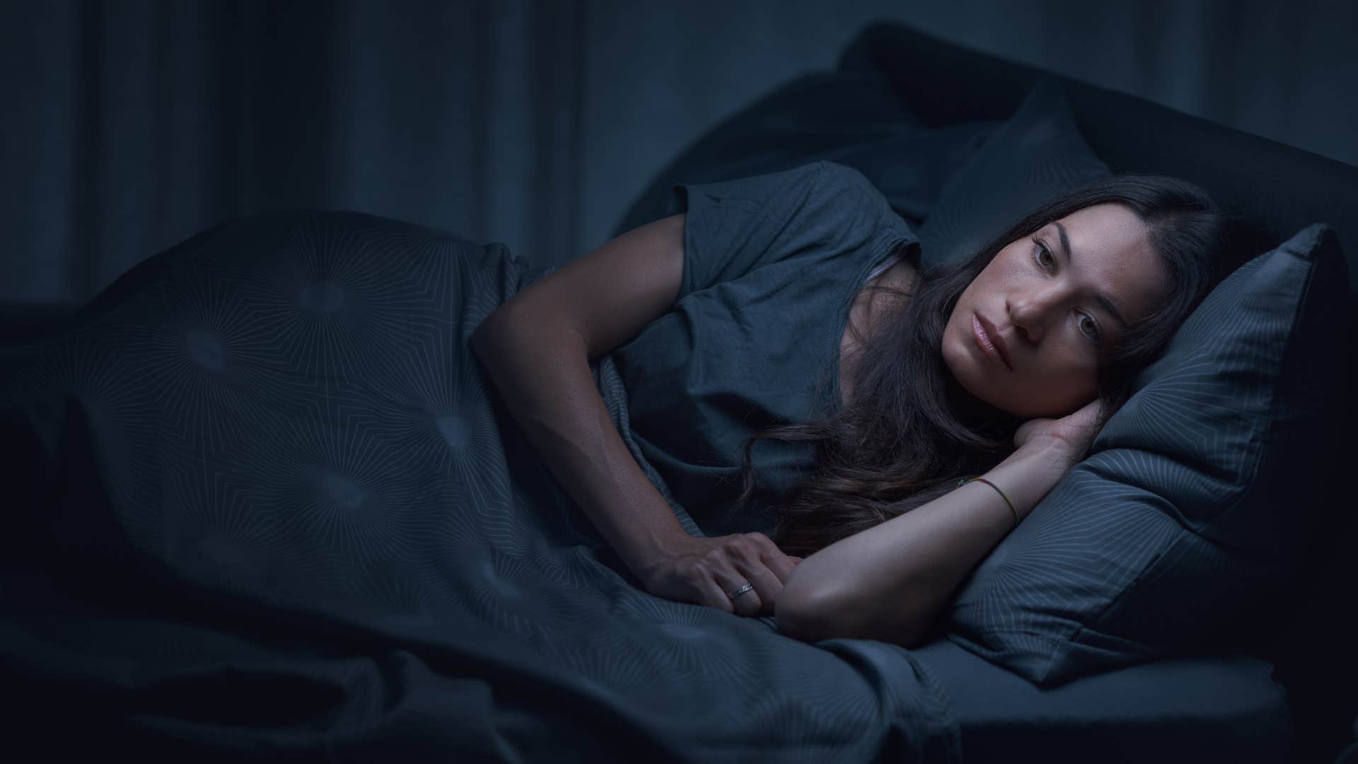 woman sleeping alone in bed