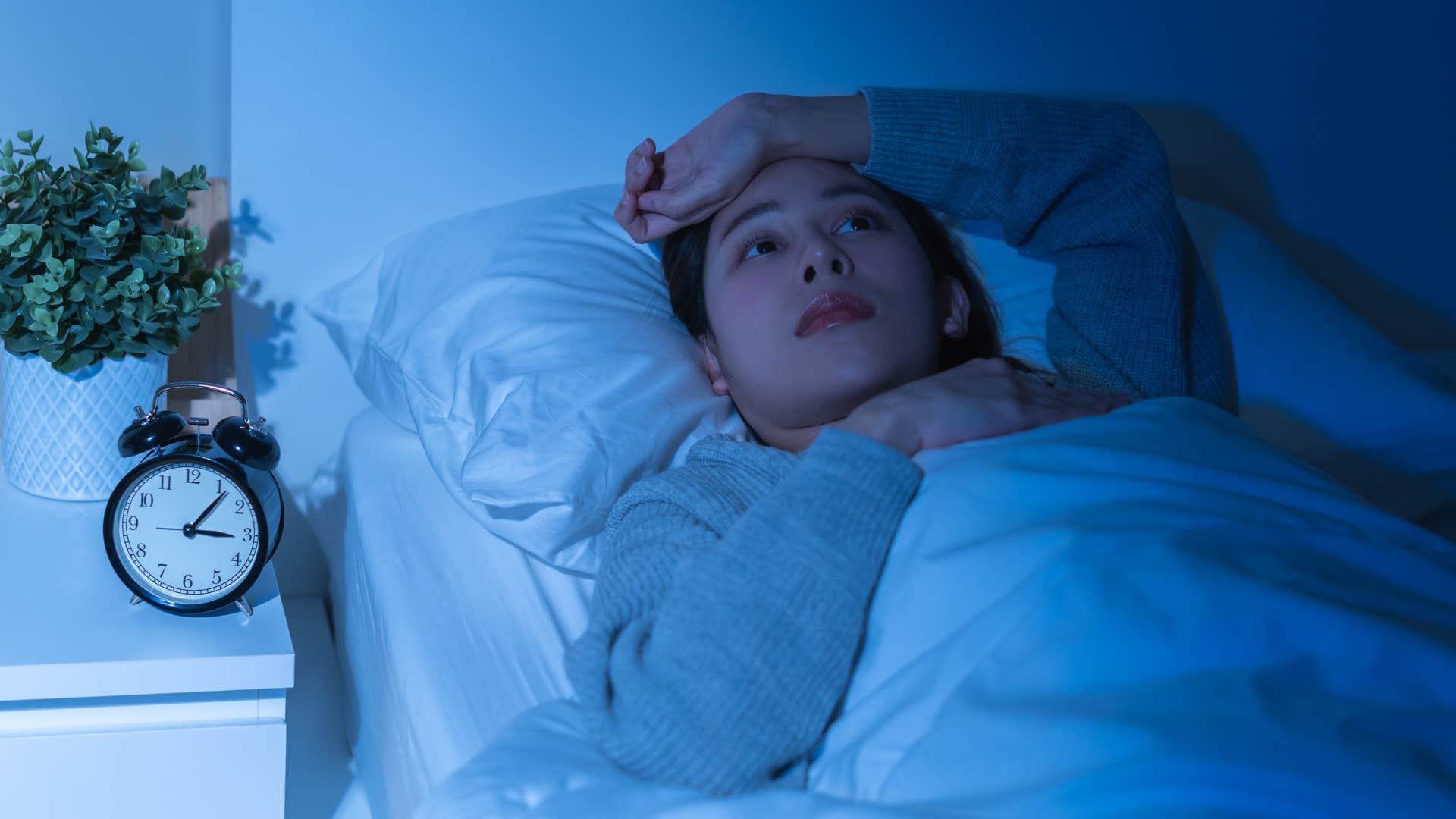 woman thinking while lying in bed