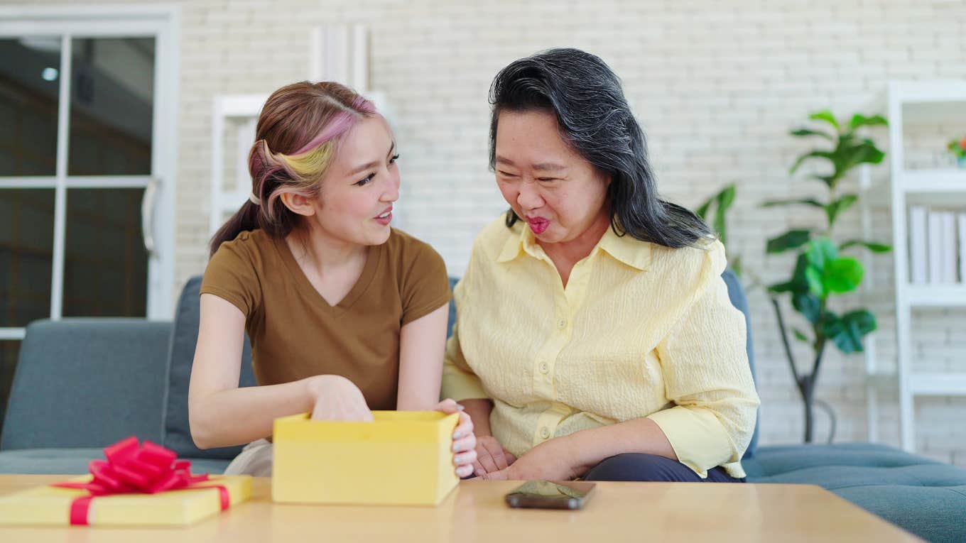 older woman giving teen girl gift
