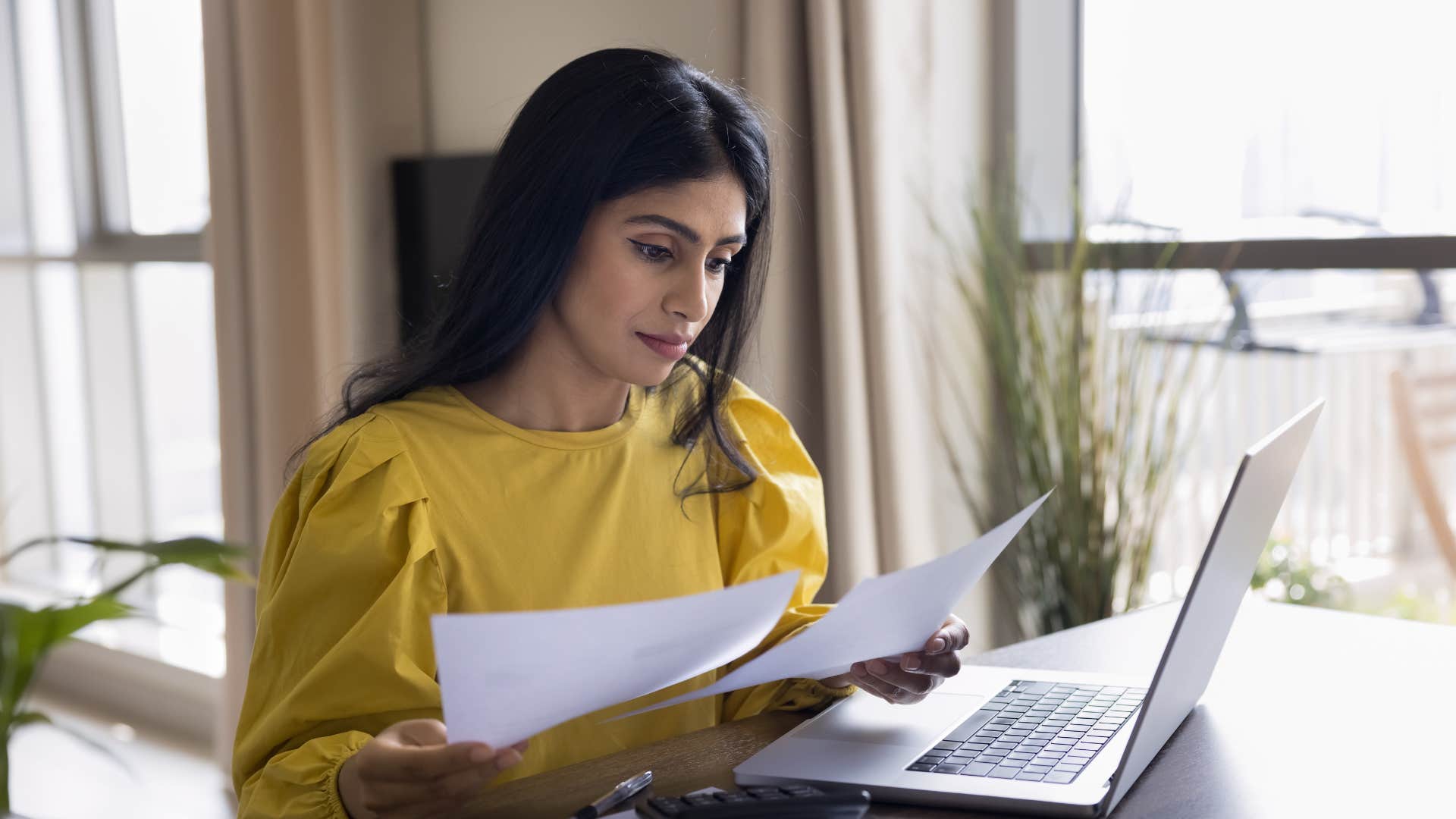 woman looking over her spending bills