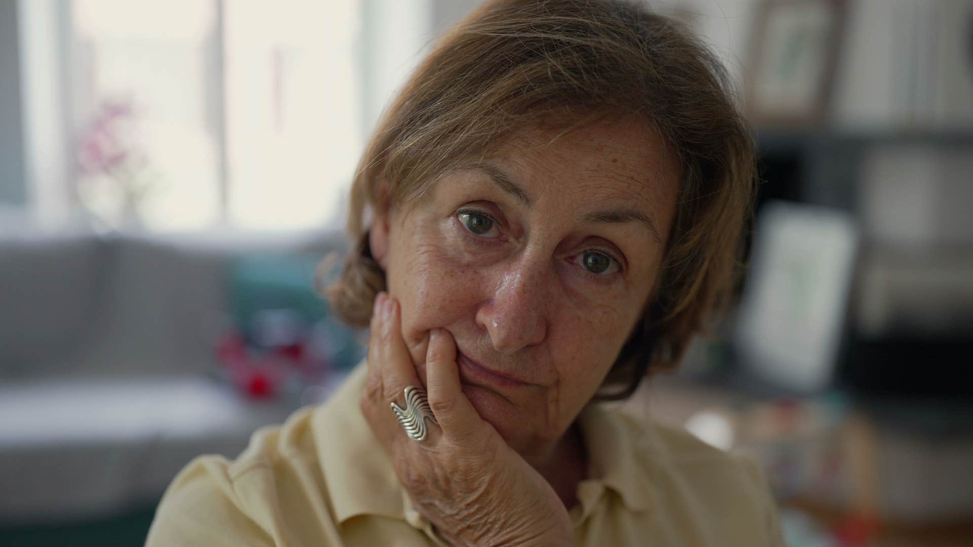 woman who's experienced a hard loss looking upset