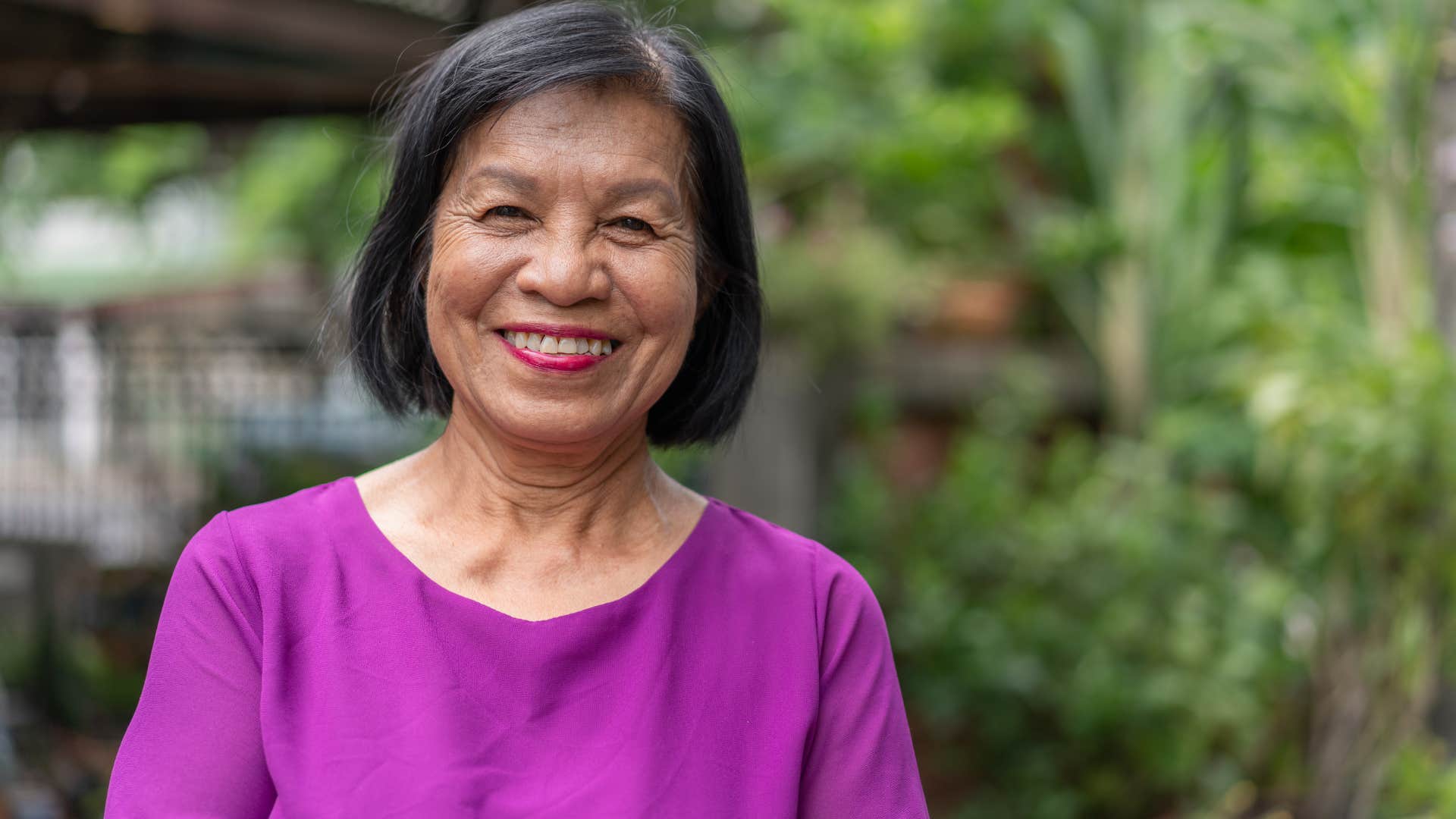 woman who's been unfairly judged smiling outside