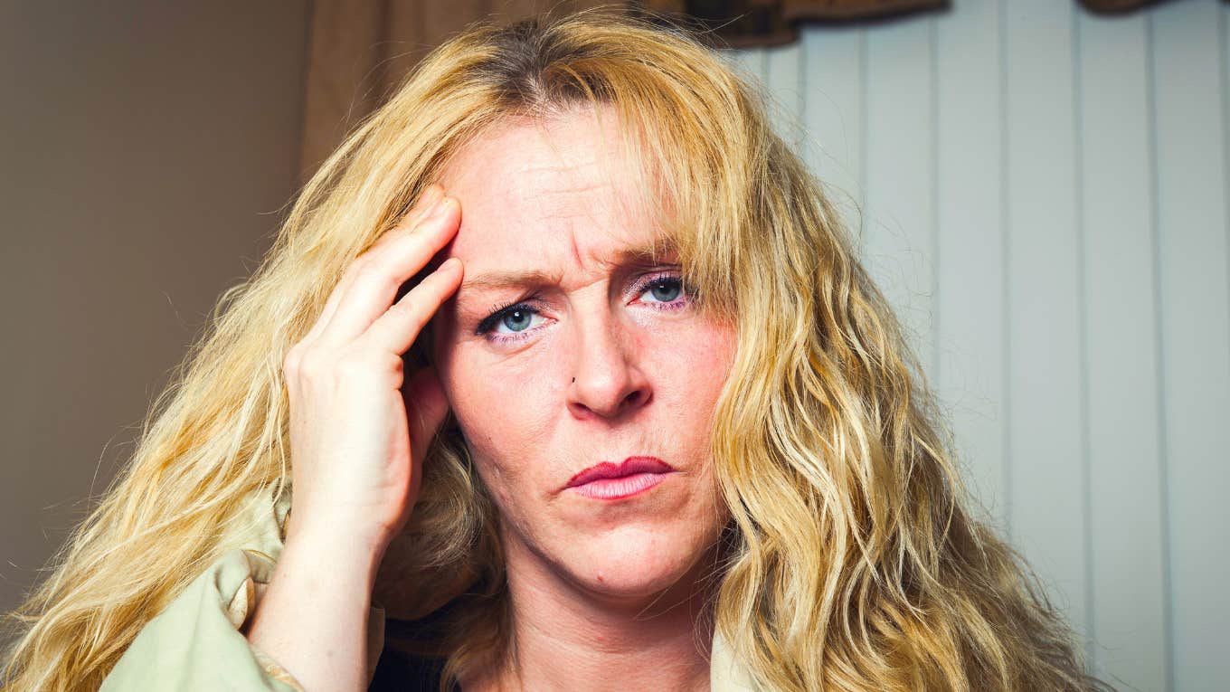 Woman looking frustrated with hand on her head, illustrating how people who constantly say exhausting phrases impact everyone around them