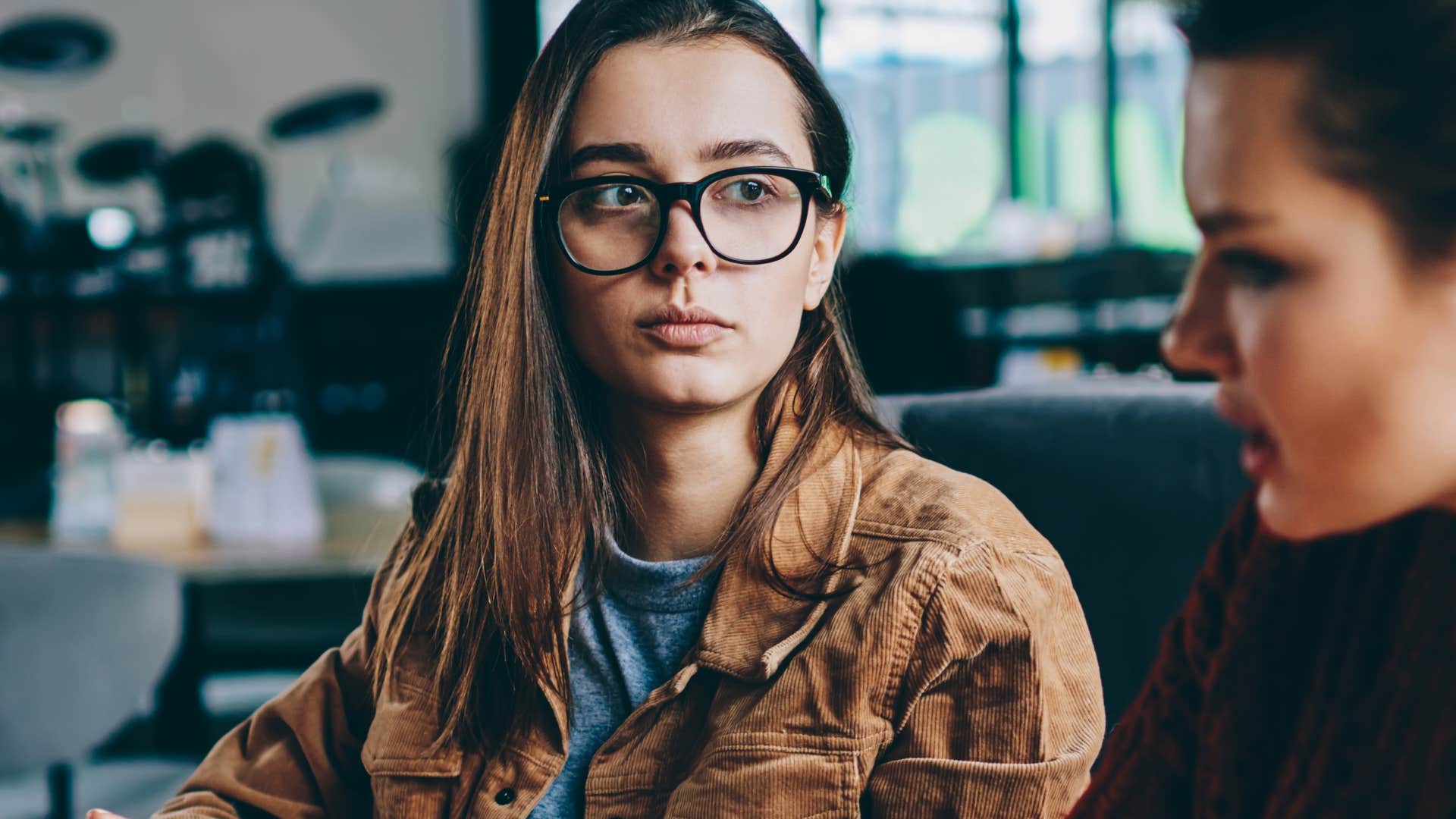 Woman saying "I'd rather talk about it now" to a friend.