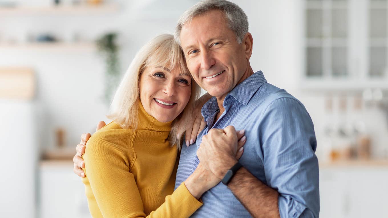 deeply in love older couple hugging and holding hands