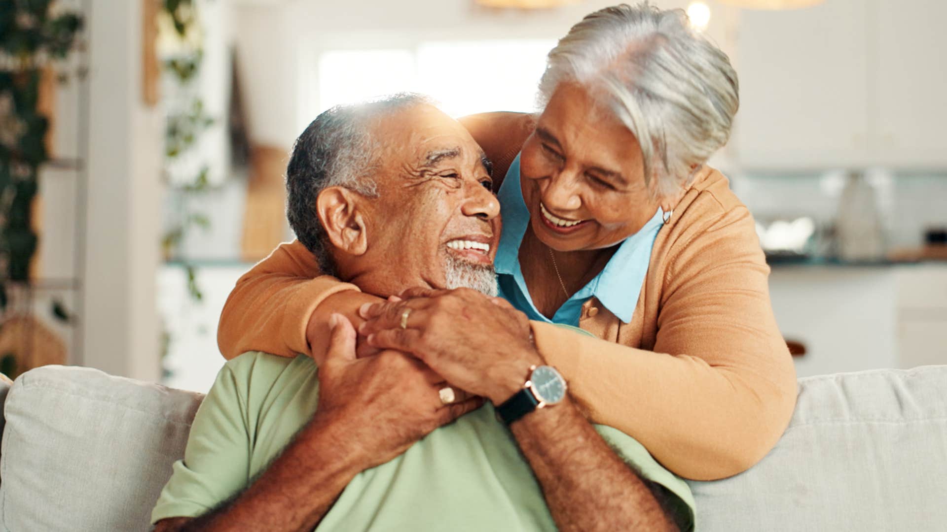 happy couple hugging on the couch