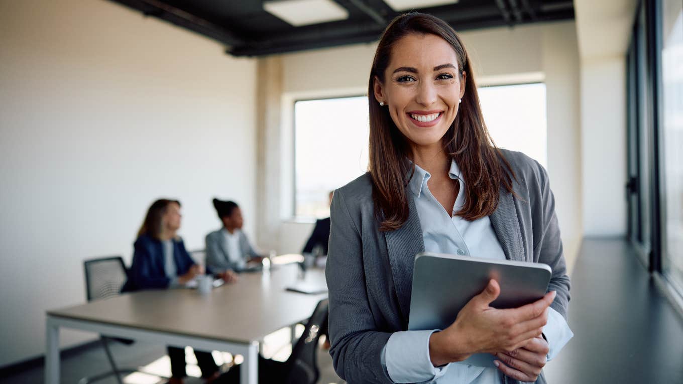 happy businesswoman in a meeting with colleagues