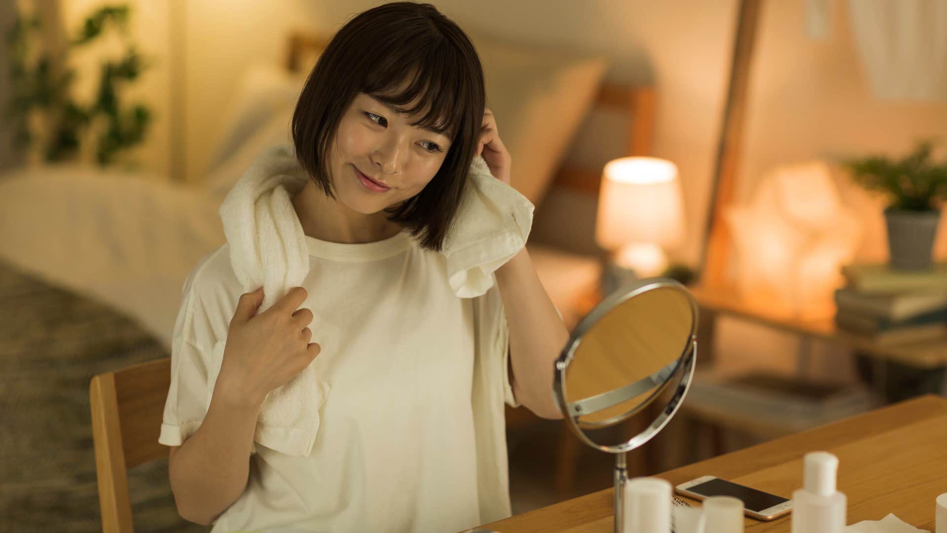 woman looking in mirror before bed