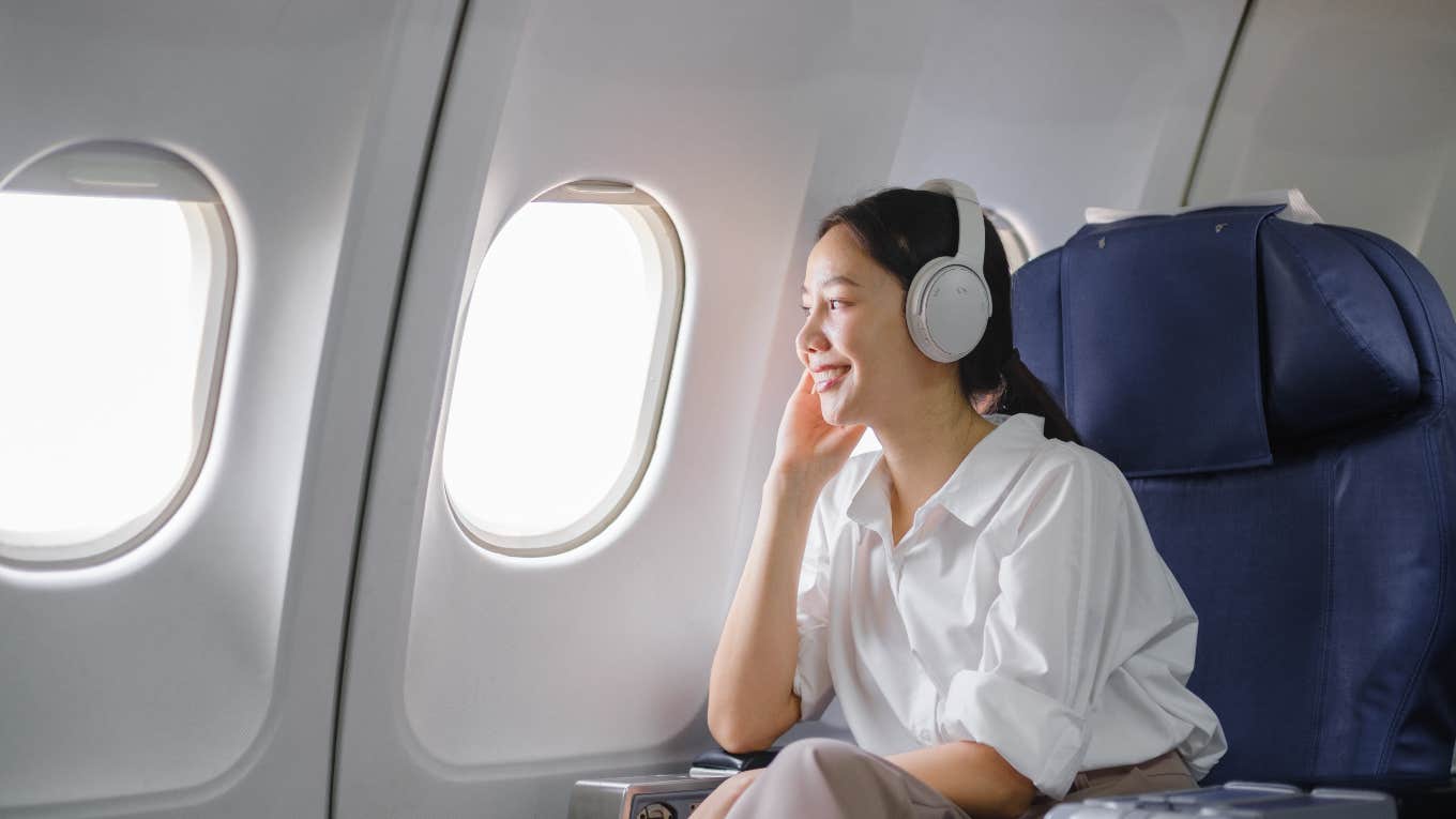 woman sitting in the window seat on a plane