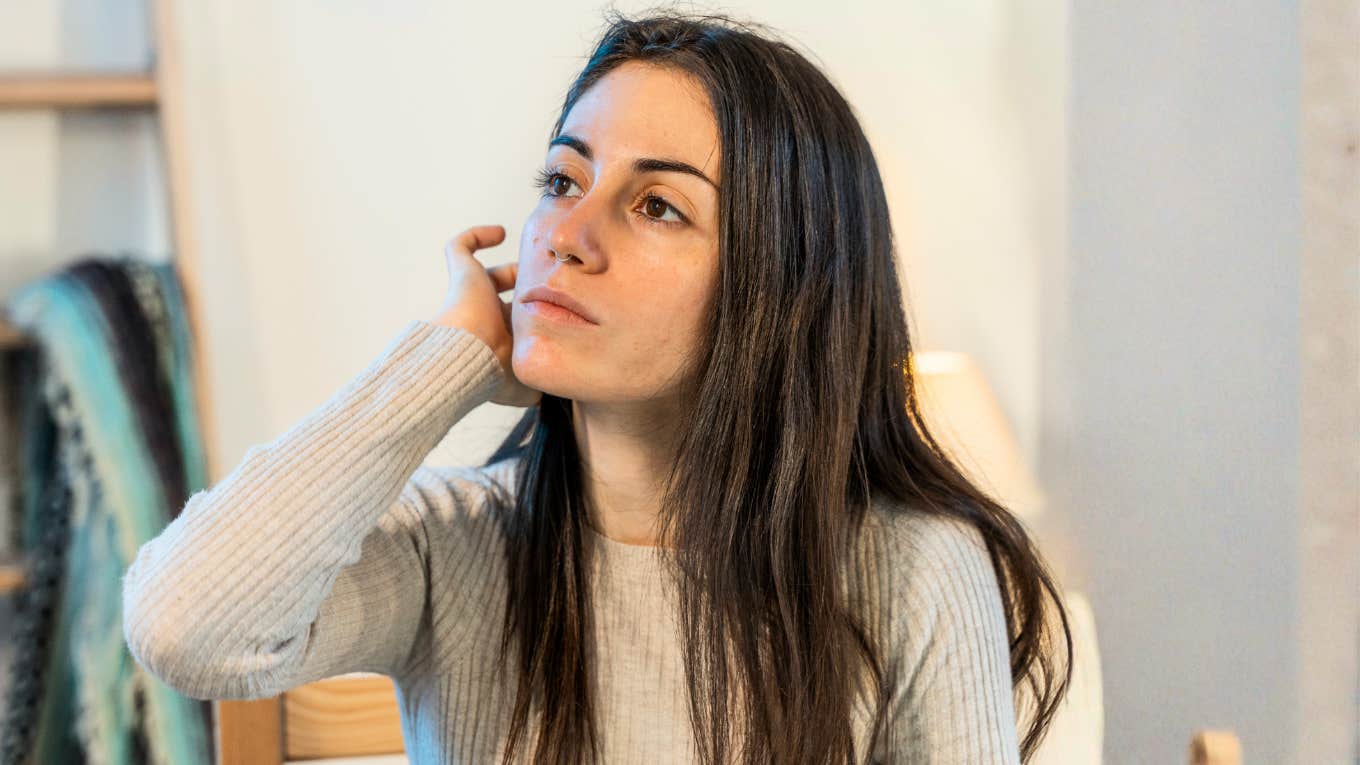 Woman at home workspace thinking deeply, showing the quiet, subtle moments that indicate she’s ready to make meaningful changes in her life.