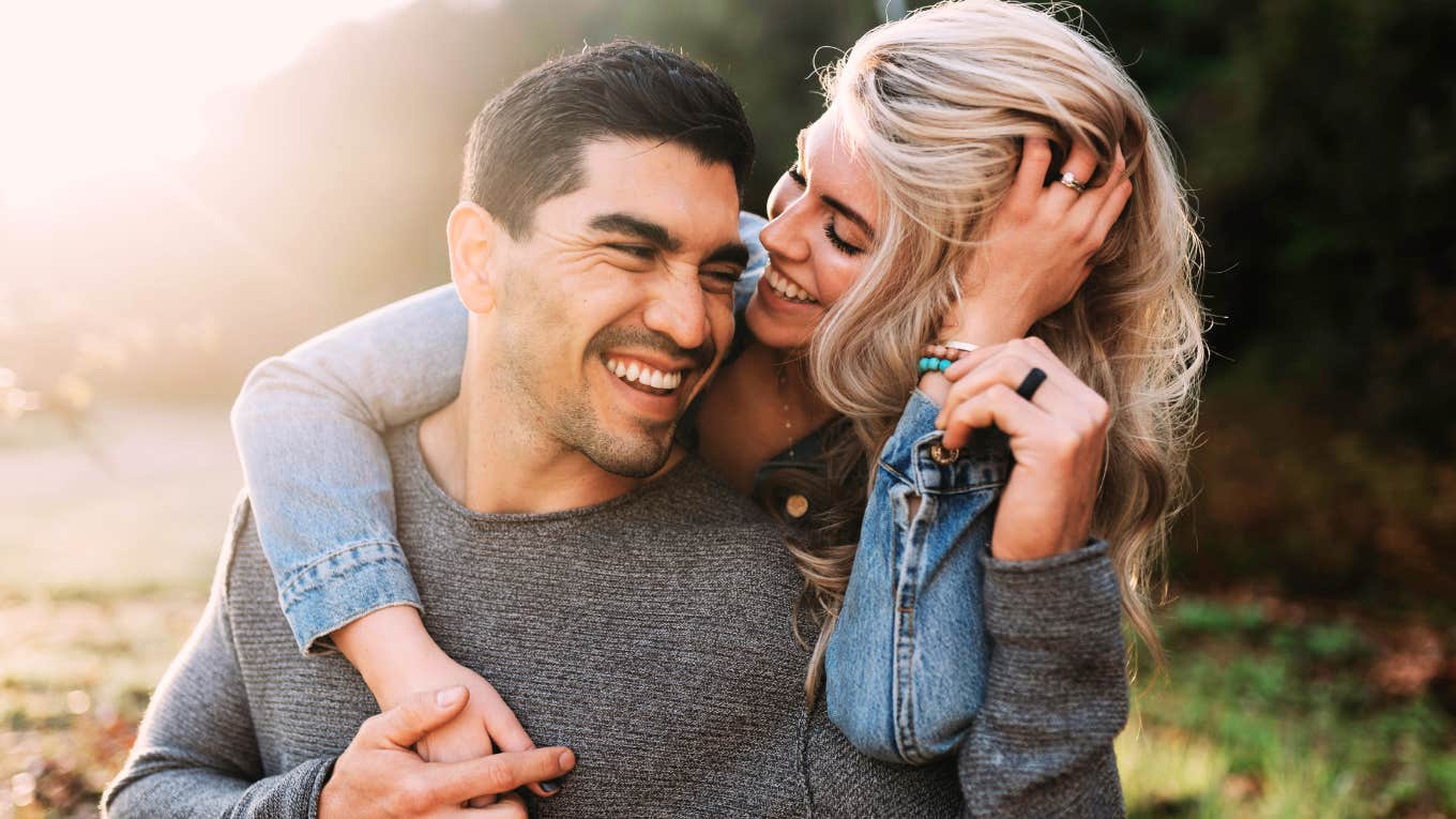 Long-married couple laughing playfully outdoors showing the meaningful milestones that make a marriage stronger by fifty.