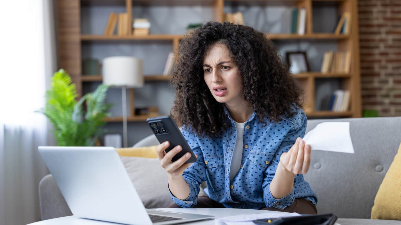 stressed woman looking at finances