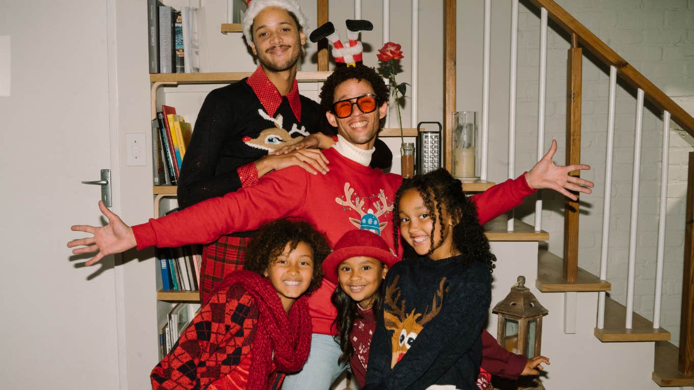 festive family in Christmas sweaters posing happily together, capturing the nostalgic holiday feeling of Christmas movies that signal the season has officially begun.
