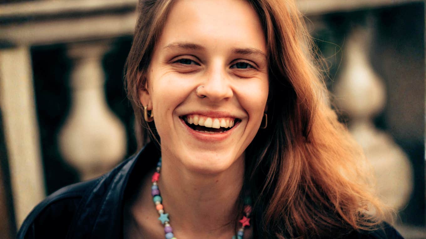 bright upbeat person radiating warm positive energy, illustrating the simple daily habits of people who never give off that heavy Debbie-downer vibe