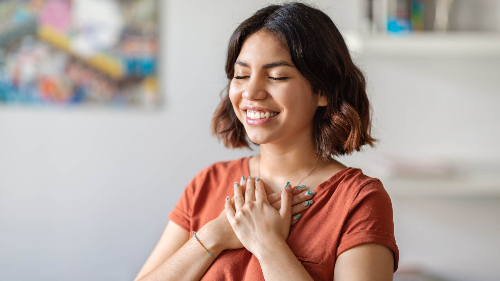 Joyful person touches heart showing way to be happy to the core