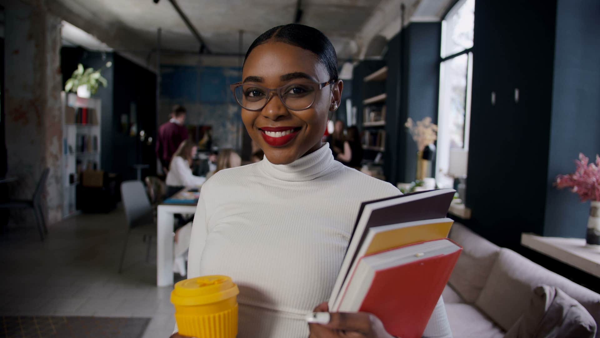 Proud person holds notebooks showing way to be happy and strong