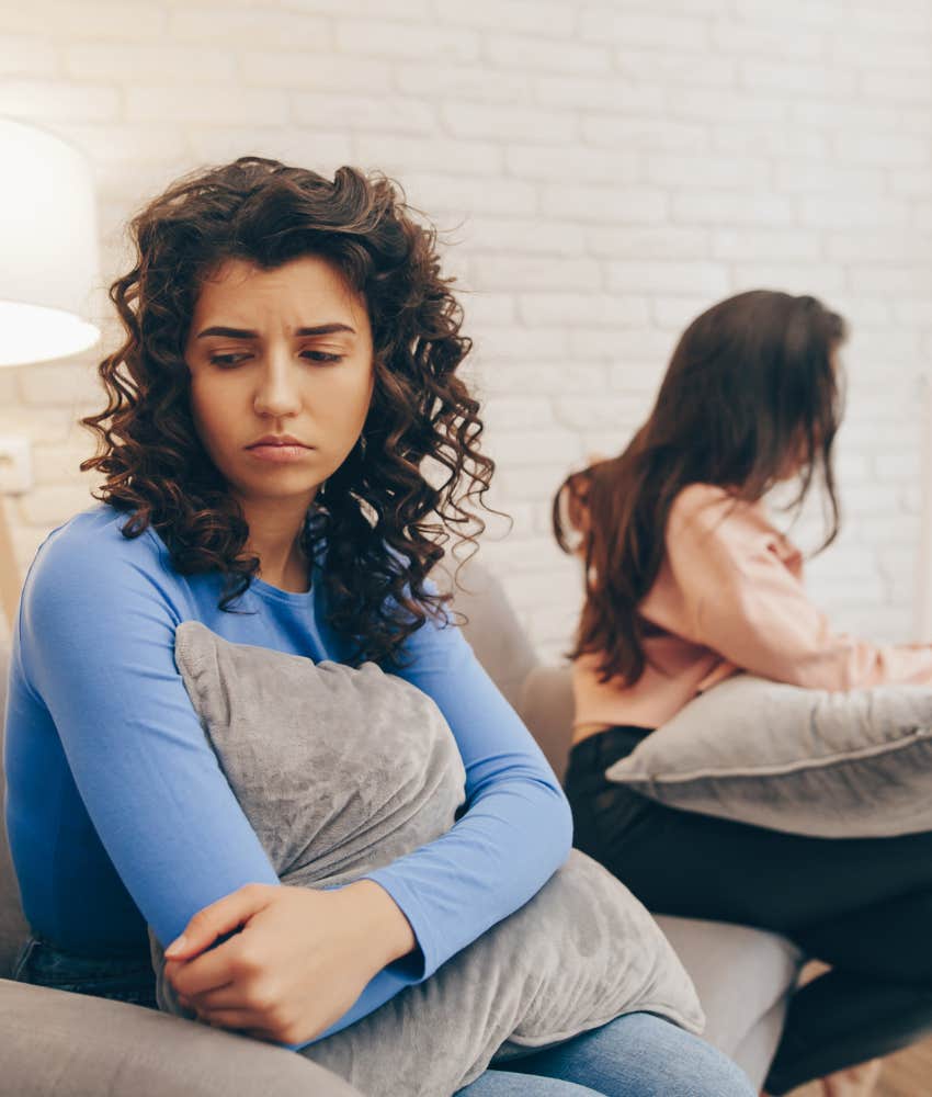 Upset person turns away from friend showing remembering backstory is happier