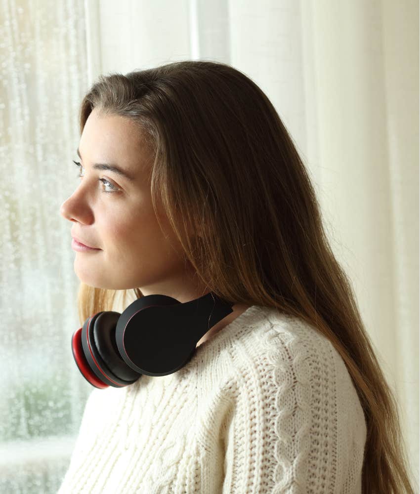 Unbothered person looks out window showing habit to put past in perspective