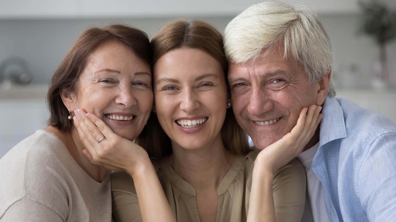 happy woman smiling with her baby boomer parents