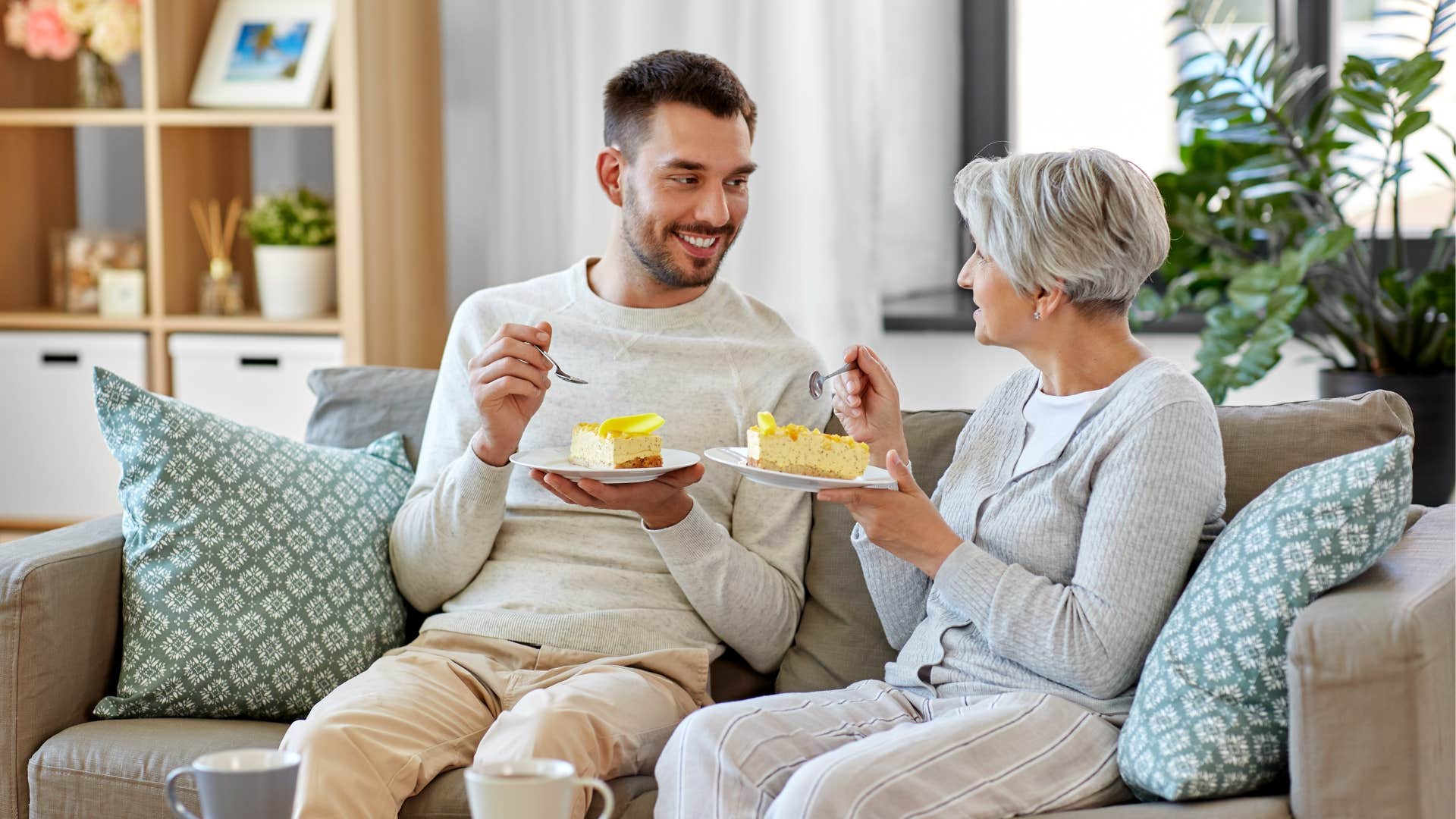man enjoying food with his boomer mother