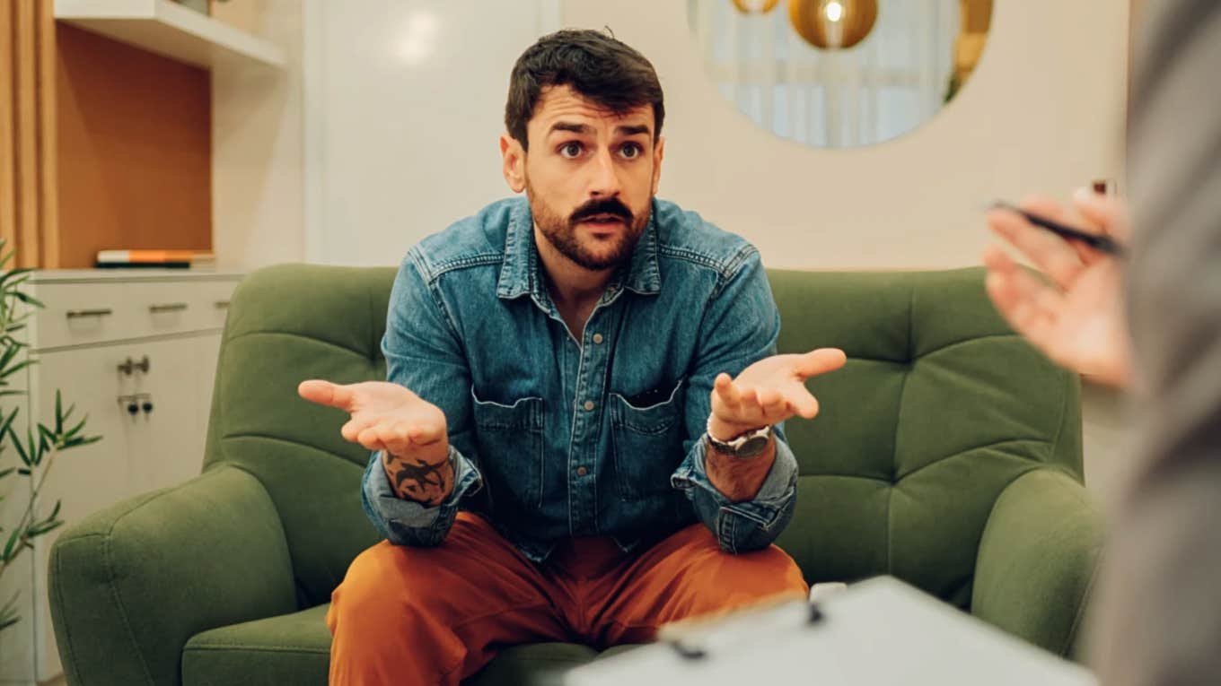 Man making a confession in therapy to a couples counselor 