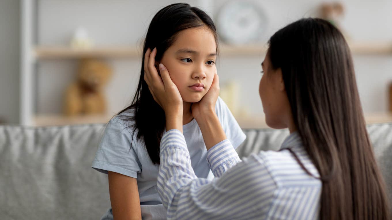 Young mother comforting her sad daughter