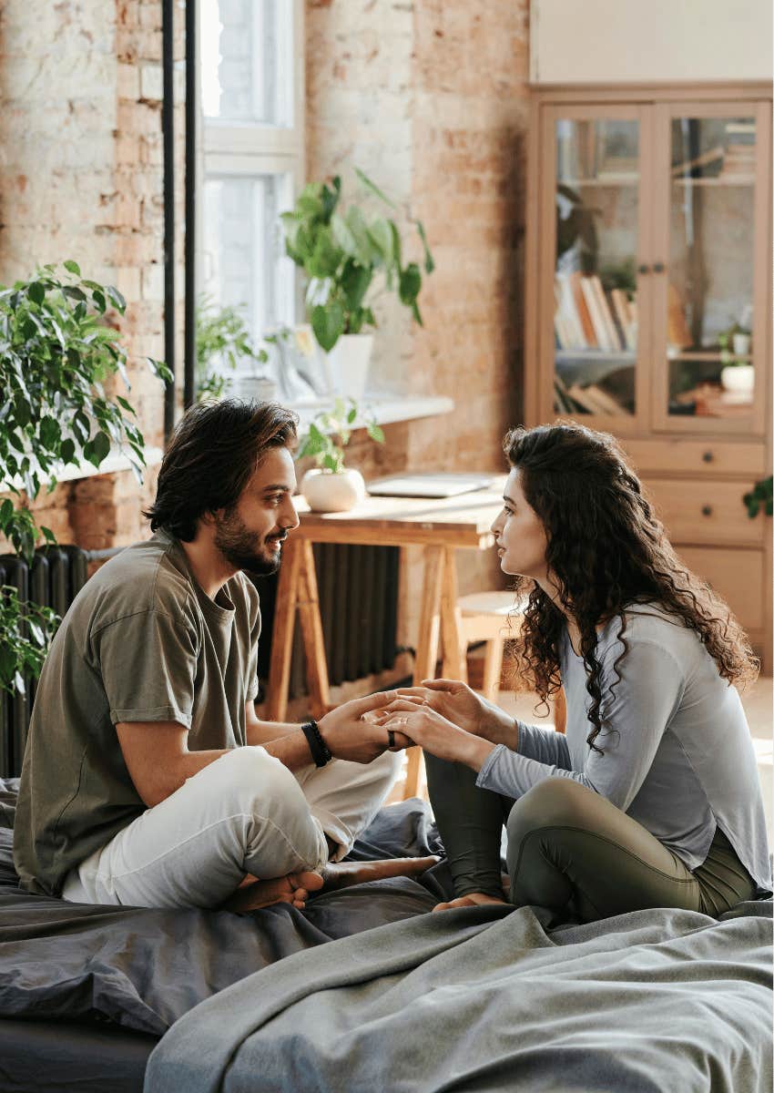 couple holding hands and talking close together