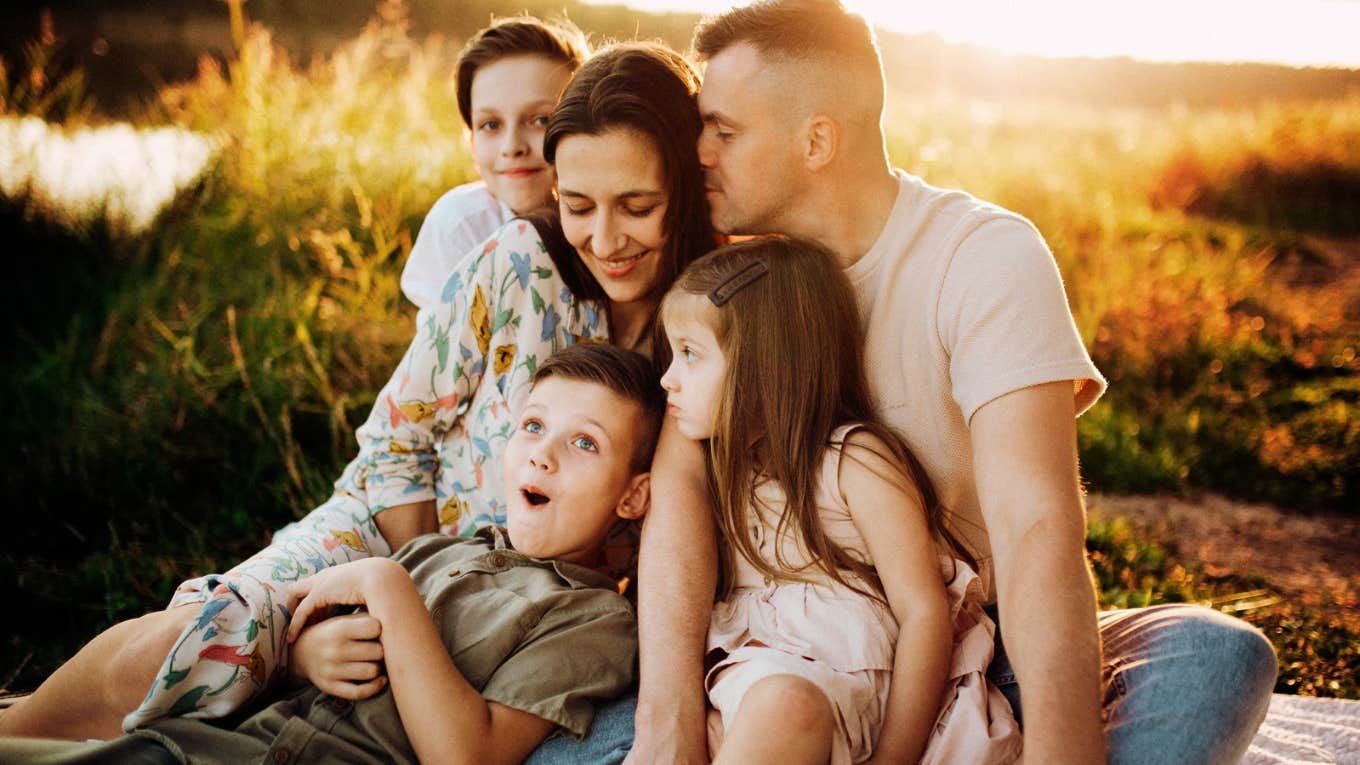 loving parents sharing a warm connected moment with their child, illustrating the simple habits that help couples grow stronger together after having kids.