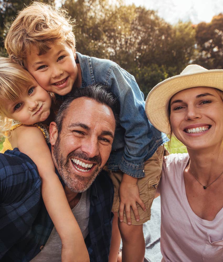 Happy couple with kids showing empathy