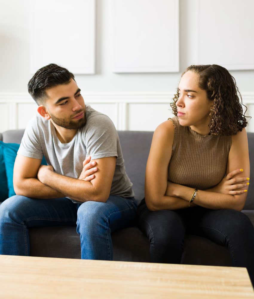 Upset couple stare and each other showing fear as sign of trouble