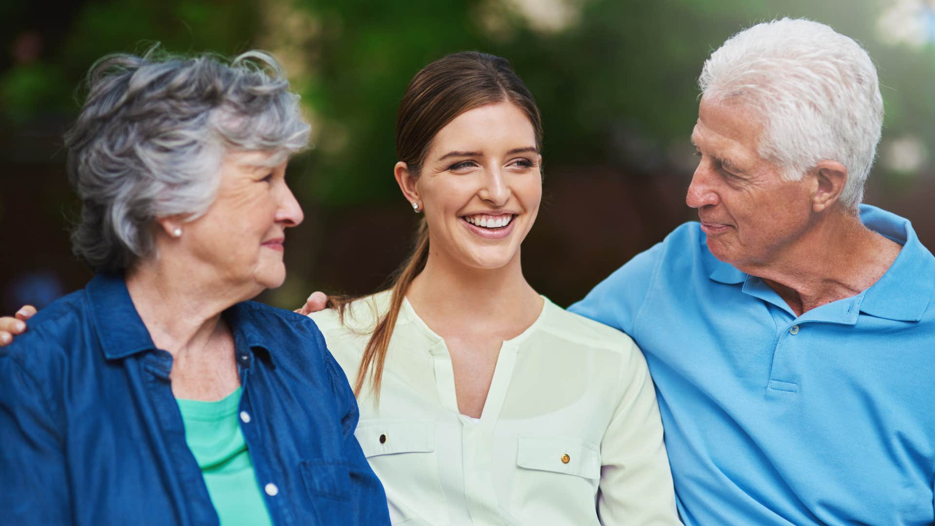 adult woman smiling next to parents