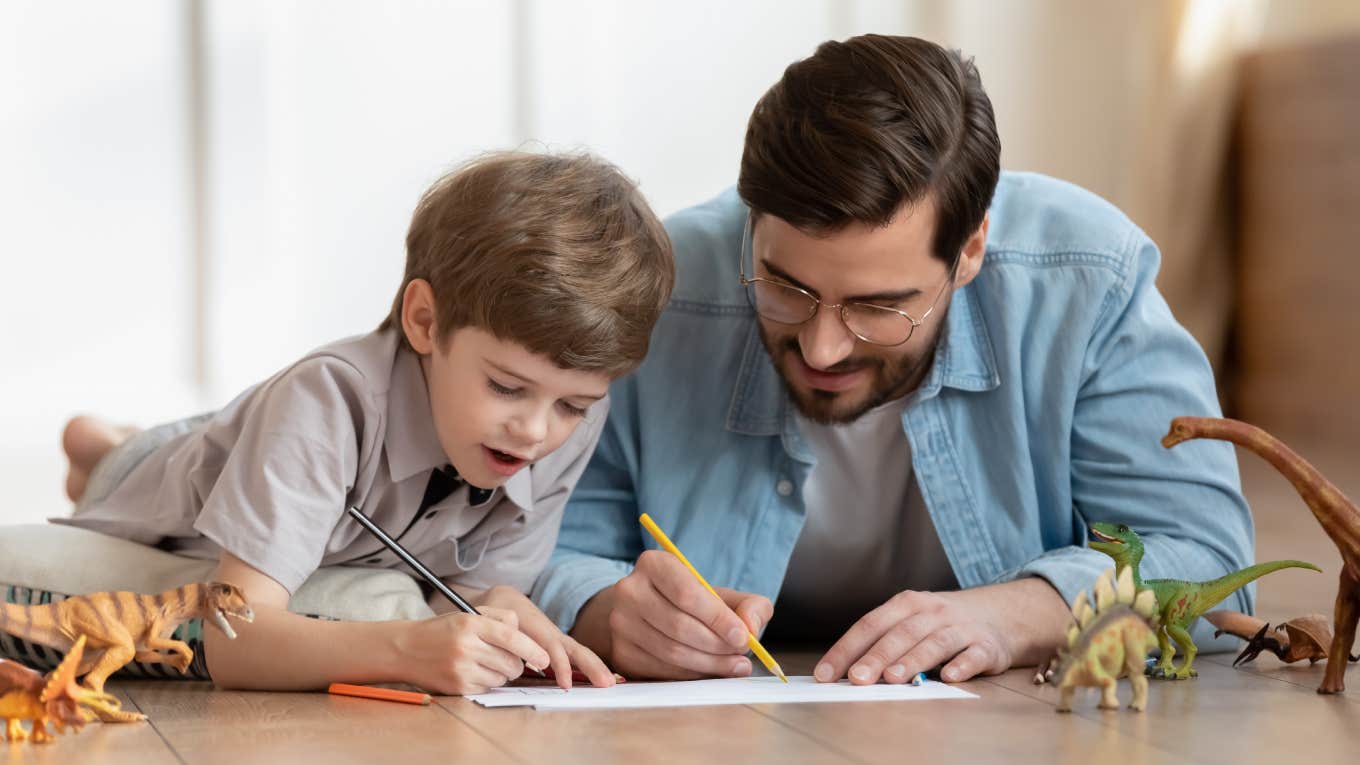 dad and son drawing on the floor