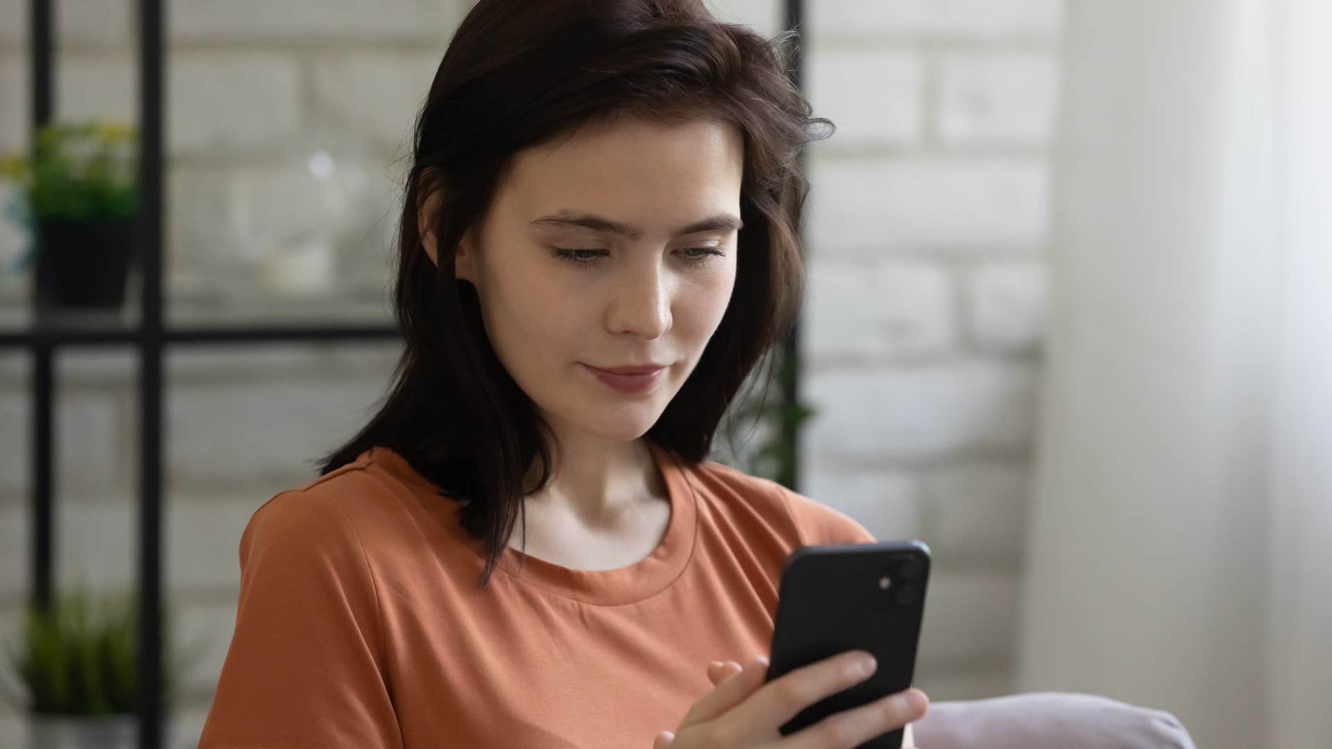 Woman consistently ignoring texts on her phone.