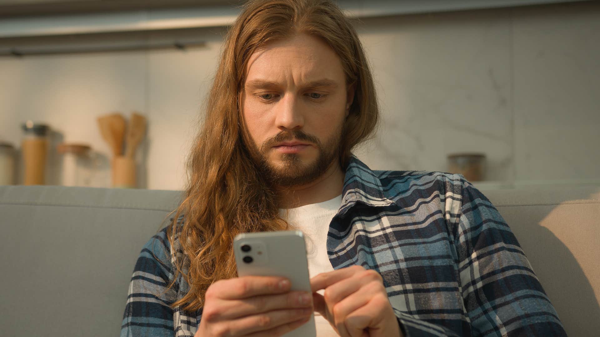 Man constantly using his phone at home.