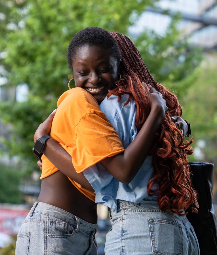 two gen z girls hugging
