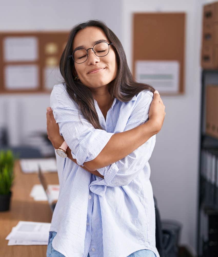 Peaceful person hugs themselves showing empowerment through self protection
